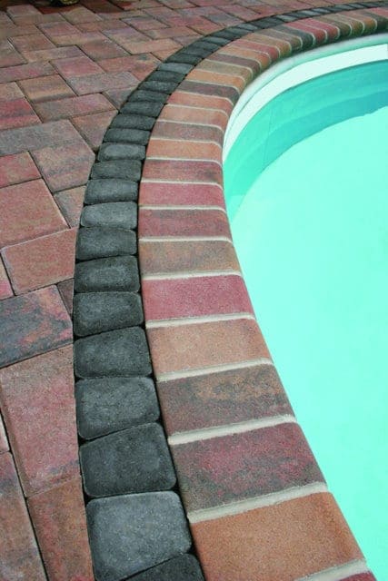 This pool deck is paved with Nicolocks 4 inch x 8 inch Fullnose pavers with their Autumn color blend.  Nicolock uses Davis Colors concrete pigments to make their custom color blends.  To learn more about Nicolocks products visit them at www.nicolock.com.