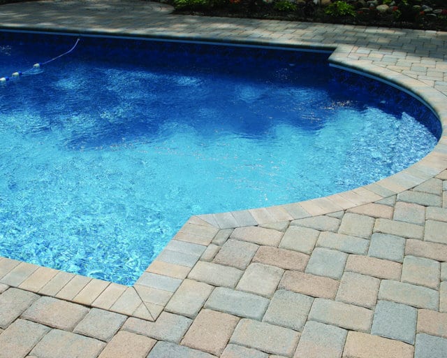 This pool deck is paved with Nicolocks Colonial Cobble pavers with their Adobe color blend.  The pavers have been laid in a herringbone pattern.  Nicolock uses Davis Colors concrete pigments to make their custom color blends.  To learn more about Nicolocks products visit them at www.nicolock.com.