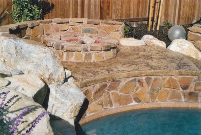This decorative concrete stamped pool deck that was colored with Davis Colors Palomino (www.daviscolors.­com). For the stamped portion they used an Old Granite patterned stamp with a Walnut colored release agent. The Concrete Contractor was Kolstads Custom Concrete - 916-660-9157. The ready mix supplier was Folsom Ready Mix - 916-355-0300 - www.folsomreadymix.­com. edit