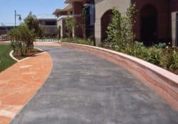 Cisco Systems' Campus - The walkway was colored with Davis Colors' Dark Gray (860) concrete color. The walls were colored with Davis Colors Brick Red and 1117 at 5 lbs per sack of cement. The walls all had varying degrees of exposure created by sand blasting the surface. The concrete had varying levels of concrete colors to achieve the random look of a washed out terrain.