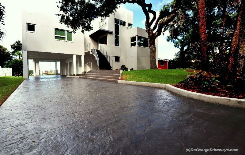 This textured concrete driveway in Saint Petersburg, FL was colored with Davis Colors Graphite (#8084 carbon black) and stamped with a seamless granite stamping skin by contractor DeGeorge Driveways.  The concrete was cleared sealed with DeGeorge Driveways’ own solvent clear sealer. To contact DeGeorge Driveways call them at 727-584-2040 or visit www.degeorgedriveways.com.