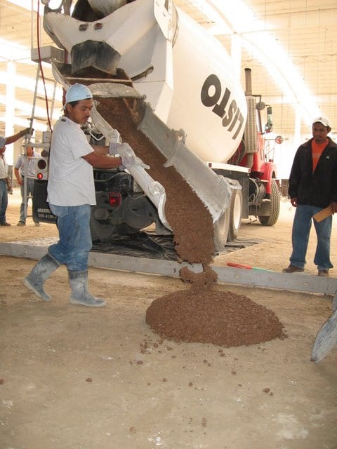 The first batch of Davis Colors Yosemite Brown colored concrete being poured from the ready mix truck.