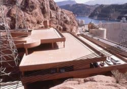 The Hoover Dam parking structure is a cast-in-place structure using pan slab forming.  It is tucked inside a steep ravine that has been partially blasted out to provide enough room for the structural footprint.  Stretching 540 ft. in length in a stepped down configuration, the structure is 165 ft. wide and three levels high at the rear, 215 ft. wide and five levels high in front.  The structure’s concrete is integrally colored to blend in with the surroundings canyon rock.  To learn more about the Hoover Dam visit the Bureau of Reclamation website – www.usbr.gov/lc/hooverdam/index or Wikipedia at http://en.wikipedia.org/wiki/Boulder_Canyon_Project#Planning_and_ageements .