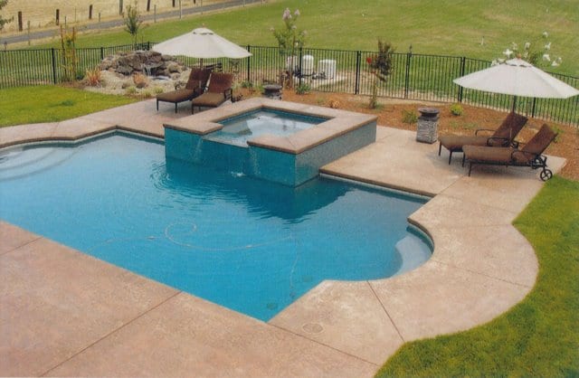 This decorative concrete stamped pool deck that was colored with Davis Colors San Diego Buff (www.daviscolors.com). For the stamped portion they used an Roman Slate patterned stamp with a nutmeg colored release agent. The Concrete Contractor was Kolstads Custom Concrete - 916-660-9157. The ready mix supplier was Folsom Ready Mix - 916-355-0300 - www.folsomreadymix.com.