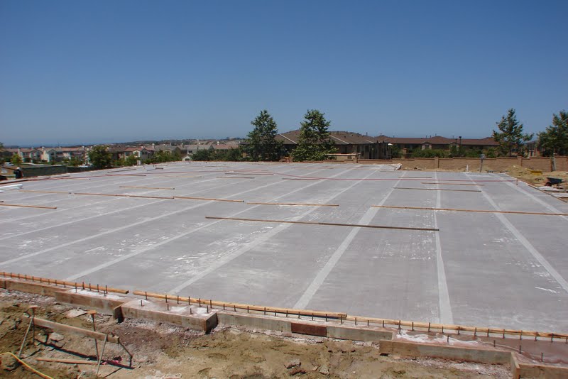 The rolls of McTech Group’s UltraCure NCF™ curing fabric have been rolled out to cover the entire colored slab.  This 7 day curing method is designed to provide thorough hydration and even curing for the colored concrete.