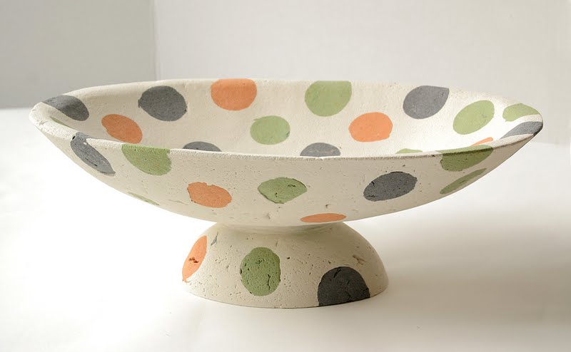 This "Multi-Colored Polkadot Basin on Stand" (16” x 11.5 x 5.5”) was made by Deborah Brackenbury through a unique process of layering hand-rolled and hand-cut colors of concrete (Davis Colors) in molds and wet-carving the green concrete. To learn more about Deborah Brackenbury’s products go to http://impurevessels.com/home.html or call 405-414-8662.