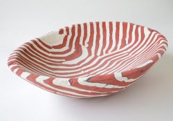 This "Red and White Lined Concrete Basin" (16" x 11.5" x 3.5") was made by Deborah Brackenbury through a unique process of layering hand-rolled and hand-cut colors of concrete (Davis Colors) in molds and wet-carving the green concrete. To learn more about Deborah Brackenbury’s products go to http://impurevessels.com/home.html or call 405-414-8662.