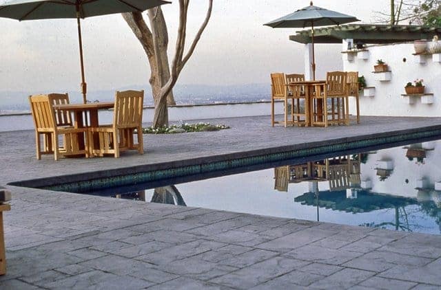 This pool deck was colored with Davis Colors Mocha and stamped with an ashlar slate stamp pattern.