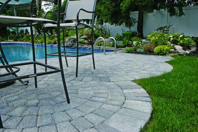 This pool deck is paved with Nicolocks Country Circle pavers with their Granite City color blend.  Nicolock uses Davis Colors concrete pigments to make their custom color blends.  To learn more about Nicolocks products visit them at www.nicolock.com.
