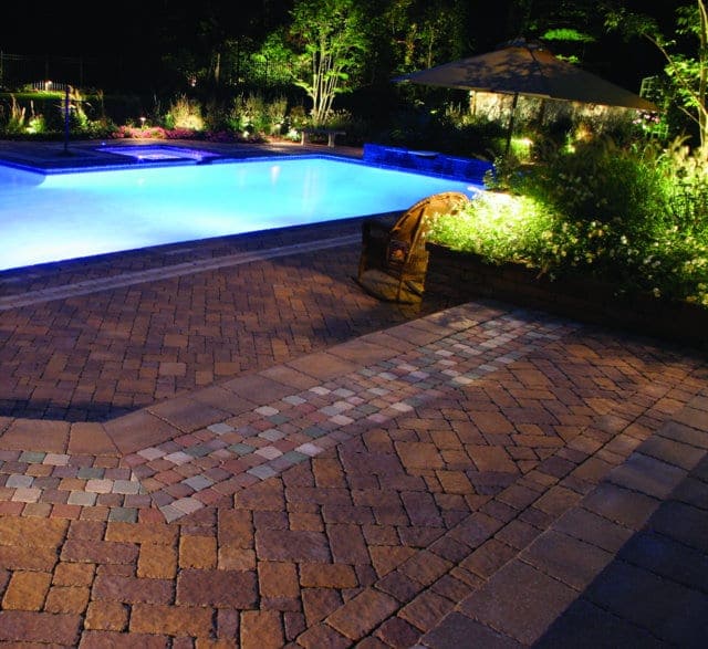 This pool deck is paved with Nicolocks Village (Antiqued) pavers with their Golden Brown color blend.  Nicolock uses Davis Colors concrete pigments to make their custom color blends.  To learn more about Nicolocks products visit them at www.nicolock.com.