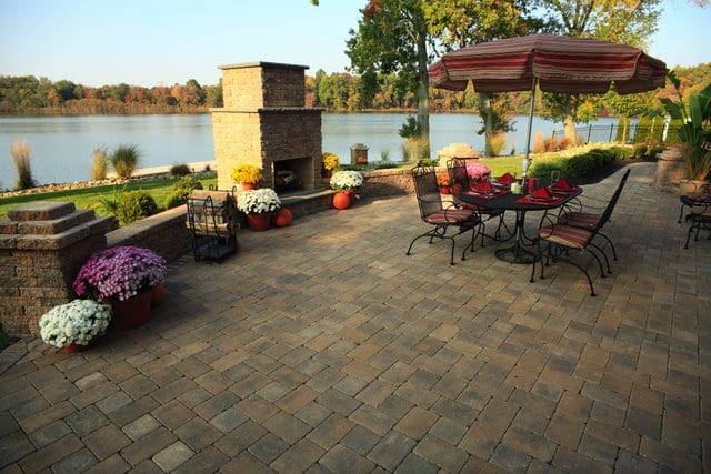 This beautiful patio was created using a combination of Nicolock pavers and Davis Colors custom concrete pigments to build a beautiful paver patio, custom wall, and elegant outdoor fireplace