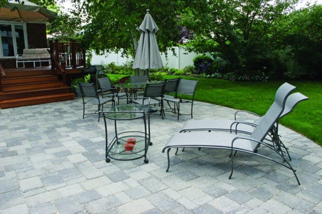 This patio is paved with Nicolocks Olde Towne (antiqued) pavers with their Granite City color blend.  Nicolock uses Davis Colors concrete pigments to make their custom color blends.  To learn more about Nicolocks products visit them at www.nicolock.com.