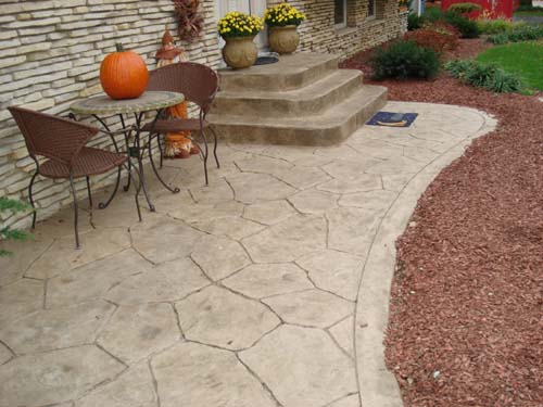 This inviting patio was colored with Davis Colors Pebble concrete color and was stamped using a Random Verona Stone stamp.  The release agent was a Desert Tan color.  The border and the steps have a slate stone texture.  The concrete work was done by Butch Bando Concrete, Inc. located in Galena, Ohio. You can reach Butch Bando Concrete, Inc. by visiting their website at www.butchbandoconcrete.com or by calling them at 740-548-7322. To learn more about Davis Colors concrete colors go to www.daviscolors.com.