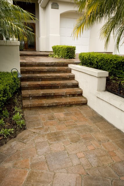 This entry way was paved with Orco Pavingstones Pacific Cobble pavers. The Pacific Cobble pavers were colored with Davis Colors pigments which Orco used to create their own Orcotta (B2) color blend. To learn more about Orcos quality products visit them at www.orcopaverswalls.com/home.htm or call them at 800-473-6725.