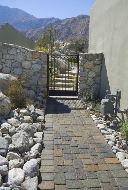 This path in Palm Springs, CA was paved with Orco Blocks Country Cobble  pavers and colored with Orcos own unique Terra Verde color blend.  Orco Block uses Davis Colors concrete pigments to create appealing color blends for their concrete pavers.  To learn more about Orcos quality products visit them at www.orcopaverswalls.com/home.htm or call them at 800-473-6725.
