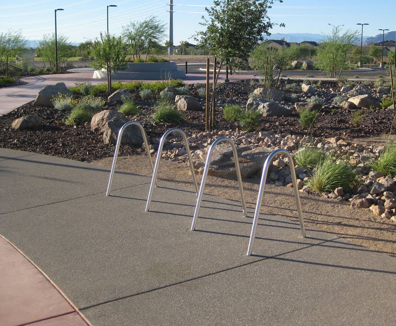 This concrete bike parking area at the Heritage Bark Park in Henderson, NV was colored with Davis Colors’ Mesa Buff and finished with an exposed aggregate.  The walkways were colored with Davis Colors’ Baja Red. The landscape design was done by the Design Workshop. To contact the Design Workshop visit their website   www.designworkshop.com or call them at 775-588-5929. To learn more about this project go to http://www.landscapeonline.com/research/article/14721.
