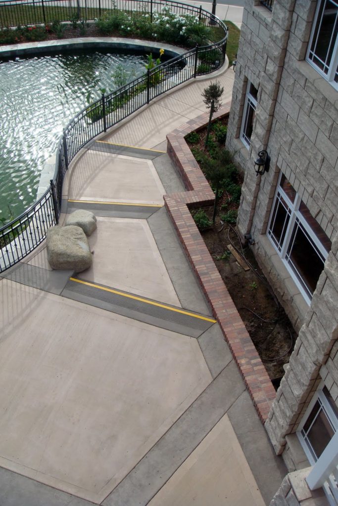This walkway was integrally colored with Davis Colors' Padre Brown with a Walnut colored release agent and Davis Colors' Meadowbrook Brown (custom color). The colored concrete was supplied by Superior Ready Mix (www.superiorrm.com).