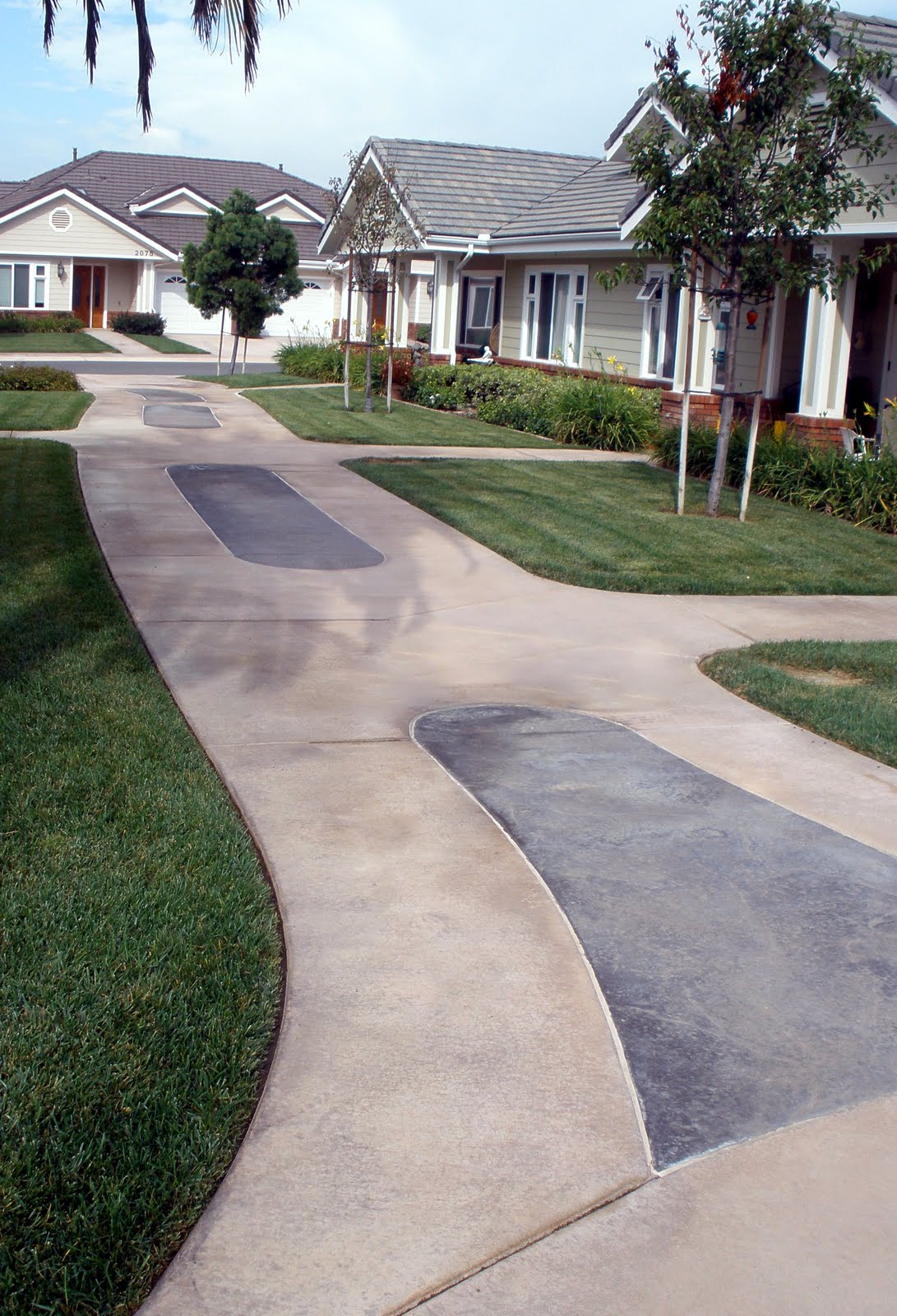 This concrete sidewalk was integrally colored with Davis Colors' Padre Brown with a Walnut release agent and Davis Colors' Meadowbrook Brown (custom color). The colored concrete was supplied by Superior Ready Mix (www.superiorrm.com).