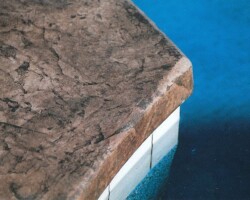 This decorative concrete stamped pool deck that was colored with Davis Colors San Diego Buff (www.daviscolors.com). For the stamped portion they used an Roman Slate patterned stamp with a nutmeg colored release agent. The Concrete Contractor was Kolstad’s Custom Concrete - 916-660-9157. The ready mix supplier was Folsom Ready Mix - 916-355-0300 - www.folsomreadymix.com. edit