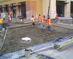 The concrete contractors are placing the concrete.