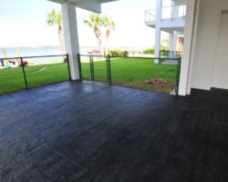 This textured concrete driveway in Saint Petersburg, FL was colored with Davis Colors Graphite (#8084 carbon black) and stamped with a seamless granite stamping skin by contractor DeGeorge Driveways. The concrete was cleared sealed with DeGeorge Driveways’ own solvent clear sealer. To contact DeGeorge Driveways call them at 727-584-2040 or visit www.degeorgedriveways.com.