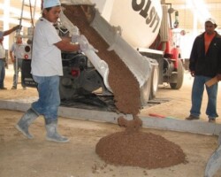 The first batch of Yosemite Brown colored concrete being poured from the ready mix truck.