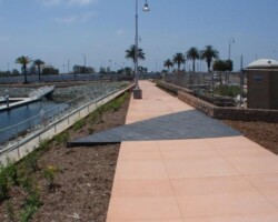 This is a photo of Pier 32 Marina located in National City near San Diego, CA. The concrete walkway was colored with Davis Colors Spanish Gold (www.daviscolors.com). The concrete work was done by Mar Vista Construction (www.marvistaconstruction.com). The concrete was supplied by Superior Ready Mix (www.superiorrm.com, sales@superiorrm.com).