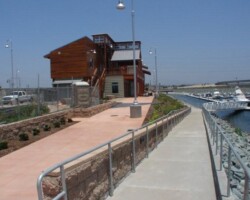 This is a photo of Pier 32 Marina located in National City near San Diego, CA. The upper concrete sidewalk was colored with Davis Colors Spanish Gold (www.daviscolors.com). The concrete work was done by Mar Vista Construction (www.marvistaconstruction.com). The concrete was supplied by Superior Ready Mix (www.superiorrm.com, sales@superiorrm.com).