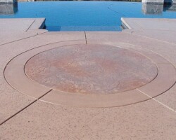 This decorative concrete stamped pool deck that was colored with Davis Colors Sandstone www.daviscolors.com. For the stamped portion they used an old granite pattern with a light gray and mesa buff release agent. The Concrete Contractor was Kolstad’s Custom Concrete - 916-660-9157. The ready mix supplier was Folsom Ready Mix - 916-355-0300 - www.folsomreadymix.com.