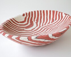 This "Red and White Lined Concrete Basin" (16" x 11.5" x 3.5") was made by Deborah Brackenbury through a unique process of layering hand-rolled and hand-cut colors of concrete (Davis Colors) in molds and wet-carving the green concrete. To learn more about Deborah Brackenbury’s products go to http://impurevessels.com/home.html or call 405-414-8662.