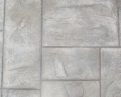 This is a close up photo of a patio in Arcadia, CA that was integrally colored with Davis Colors’ Omaha Tan. The contractor used an Ashlar Slate stamp pattern along with an antique release agent.